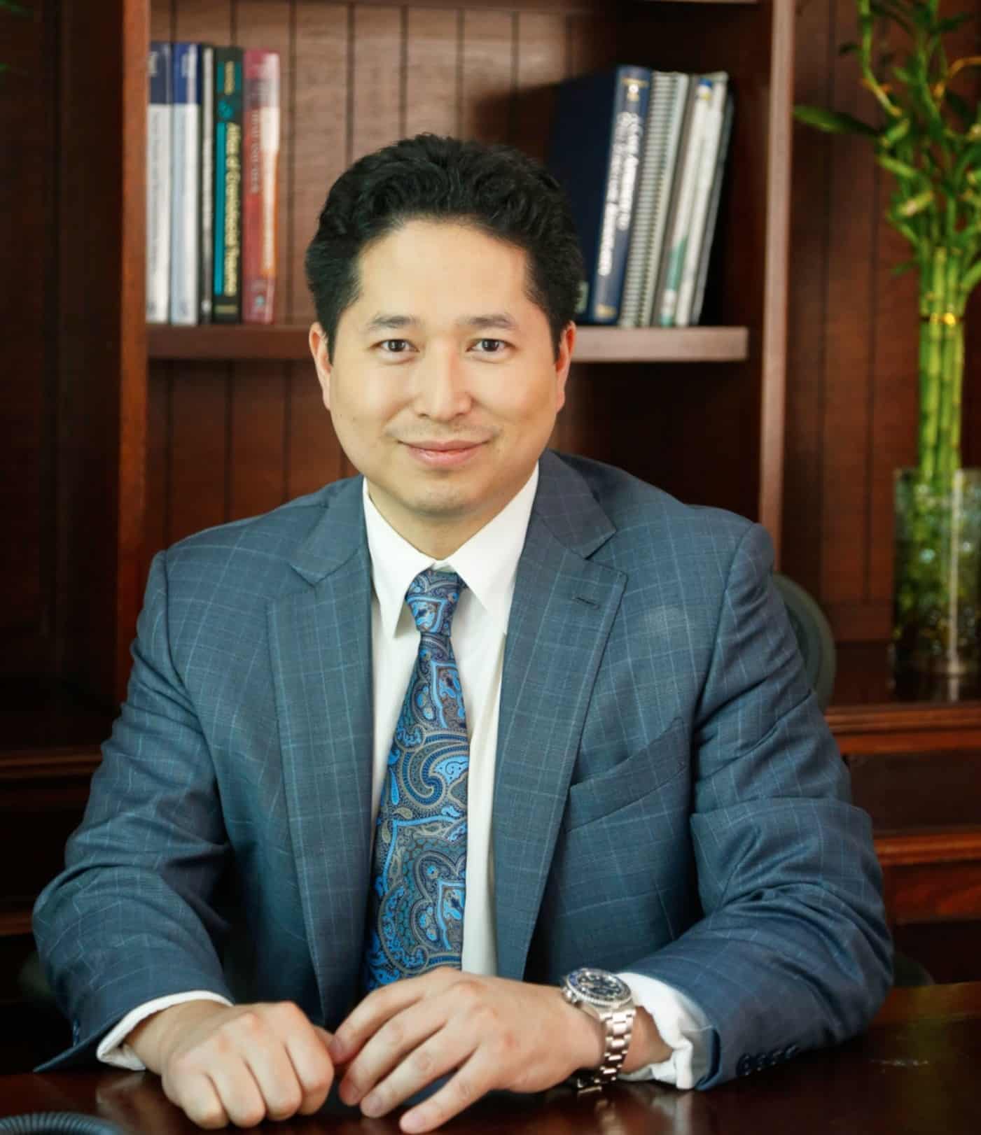 Dr. Johnny Mao seated in his office