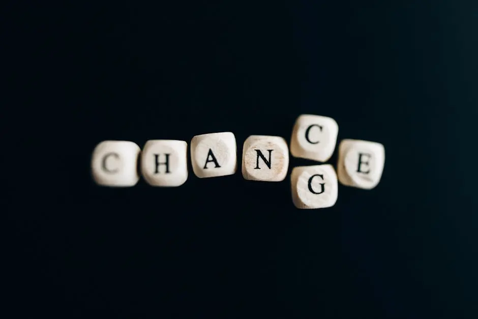 Letter dice forming the word ‘Change’ on a dark background, symbolizing transformation and opportunity.