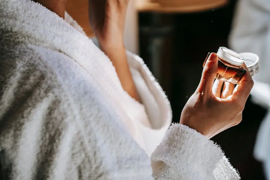 Close-up of woman applying natural cream during daily skincare routine, emphasizing self-care and wellness.